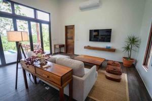 a living room with a couch and a table at Cheerful 2 bedroom Villa with Pool in Benque Viejo del Carmen