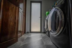 a laundry machine in a room with a door at Modern Villa Overlooking Macal River Valley in Benque Viejo del Carmen +4 photos