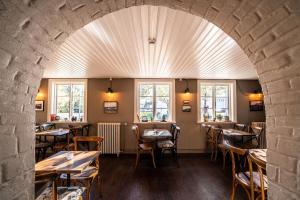 an archway in a restaurant with tables and chairs at SKYR Guest House in Hveragerði