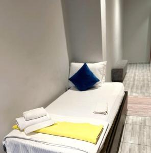 a small bed with blue and white pillows on it at Mayata Pera in Istanbul