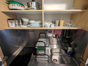 a kitchen sink with plates and dishes on shelves at Casa Campo de' Fiori in Rome