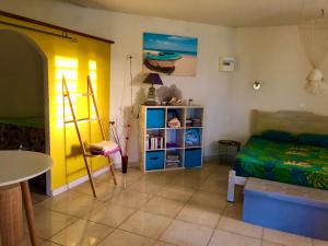 1 dormitorio con cama y estante para libros en Kaz Alberto Guadeloupe, en Sainte-Rose