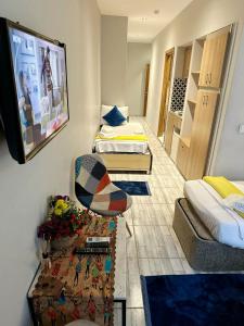 a room with two beds and a tv and a couch at Mayata Pera in Istanbul
