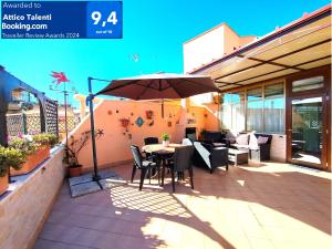 - une table avec un parasol sur la terrasse dans l'établissement Attico Talenti, à Rome