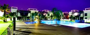 a large swimming pool in front of a building at La Zenia in Playas de Orihuela