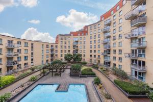 an apartment building with a pool in front of it at 5-Star Kings Cross Home with Gym - Central London in London