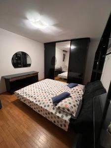 a bedroom with a bed and a large mirror at Lazar TERRACE Apartment in Izola