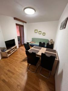a living room with a table and chairs and a couch at Lazar TERRACE Apartment in Izola