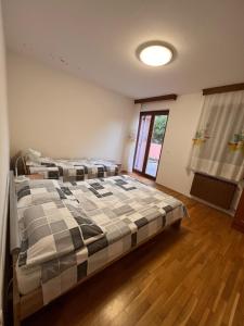 a bedroom with two beds and a window at Lazar TERRACE Apartment in Izola