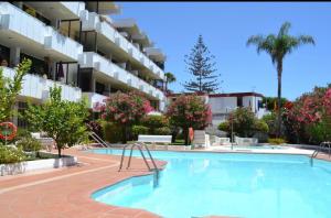 a swimming pool in front of a apartment building at Ocean blue 405 in San Bartolomé