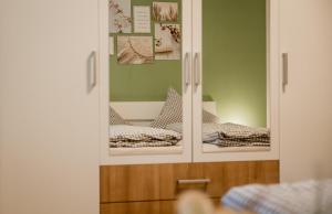a mirror with a reflection of a bed in a room at Haus Avallon in Cochem +42 photos