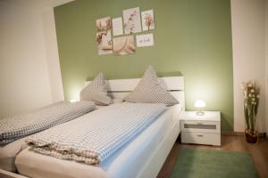 two beds in a room with green walls at Haus Avallon in Cochem