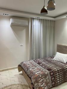 a bedroom with a bed and a window at Hotel apartment for rent Mohandsen in Cairo