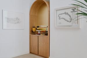 a hallway with an archway with a wooden cabinet at Prinsotel La Caleta in Ciutadella