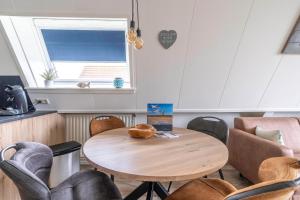 a table and chairs in a room with a window at Anna 222 in De Koog