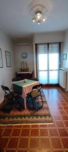 ein Wohnzimmer mit einem Tisch und 2 Stühlen in der Unterkunft Casa Robert in Alessandria
