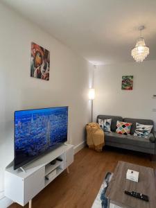 a living room with a large flat screen tv at New Peaceful Luxury Home with free ParkingWiFi Sheffield in Sheffield