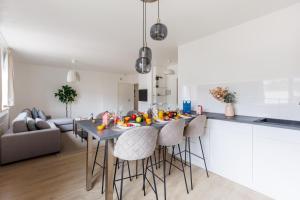 a kitchen and living room with a table and chairs at Sweet Inn - Michel Ange in Brussels