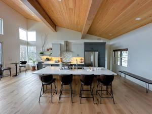 an open kitchen with a large island in the middle of a room at 1A Maple Lodge Stunning luxury Scandinavian style home with great views in Bethlehem