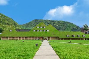 a building covered in grass with a pathway in front at Villa Hikone Castle in Hikone