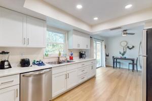a kitchen with white cabinets and stainless steel appliances at Alta Vista Respite in Sarasota