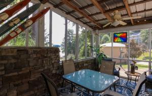 a patio with a table and chairs and a stained glass window at House #14 Pelican Sunrise (no pets) Lake View in Centre