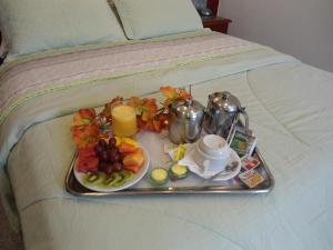 a tray of breakfast food on a bed at Maxim Plaza Hotel in Juiz de Fora