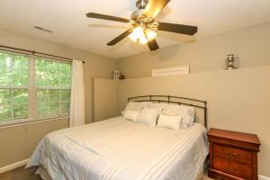 a bedroom with a bed with a ceiling fan at House #17 On The Rocks (no pets) Lake View in Centre