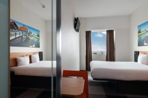 a hotel room with two beds and a window at easyHotel Amsterdam Zaandam in Zaandam