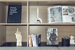 a book shelf with books and a fork and a knife at YUP Hotel in Hasselt
