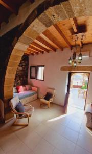 a living room with a couch and a table at Yiannis Village house in Asklipiḯon