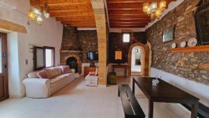 a living room with a couch and a table at Yiannis Village house in Asklipiḯon