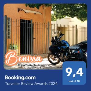 a motorcycle parked in front of a fence at Departamento Benissa en San Juan in San Juan