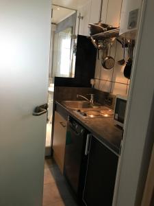 a small kitchen with a sink and a counter at Lifestyle Apartments - CityLoft in Coburg