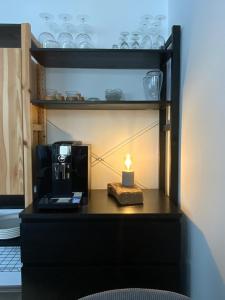 a candle sitting on a table with a coffee maker at Lifestyle Apartments - CityLoft in Coburg