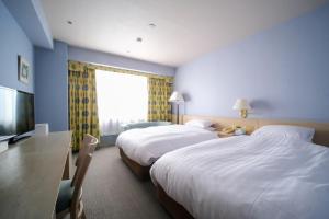 Postel nebo postele na pokoji v ubytování Yuzawa Royal hotel + 30 fotografií