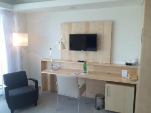 Televízia a/alebo spoločenská miestnosť v ubytovaní Hotel Erwin Junker