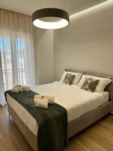 a bedroom with a large bed with two towels on it at Casa Magrè in Agrigento