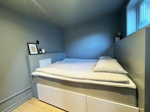 a small bedroom with a bed in the corner at A charming little cottage in beautiful Hunnebostrand in Hunnebostrand