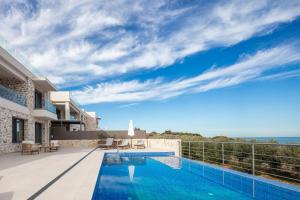 a villa with a swimming pool with a view at Oinolithos Luxury Villas in Kalamaki Chanion +42 photos
