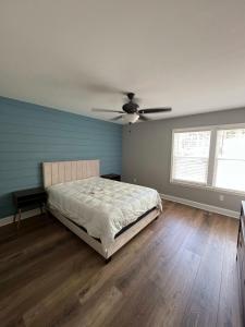 a bedroom with a bed and a ceiling fan at House #41 Moonset Vista House (Pet Friendly) in Centre