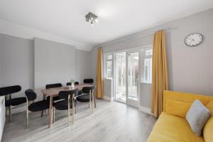a living room with a yellow couch and a table at Edgware Oasis: Modern Haven near Tube & Park in Edgware +12 photos