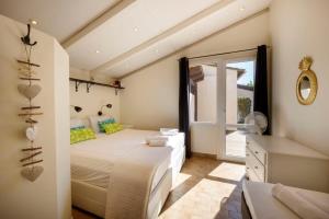 a bedroom with a large bed and a window at 06V - Beautiful villa with spa pool and tennis in Biot