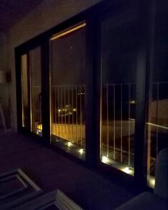 a window with a view of a city at night at Cal Cintet in Vilanova de Meyá