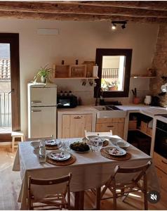 a kitchen with a table with plates of food on it at Cal Cintet in Vilanova de Meyá