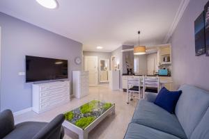 a living room with a blue couch and a table at Sailor Rest en Costa Sol in Costa Del Silencio