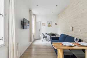 a living room with a blue couch and a table at 102-Suite Lenny - Superb apartment in Paris in Paris