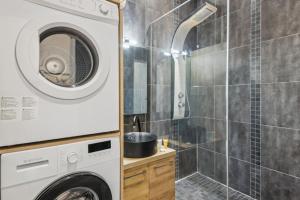 a washing machine in a bathroom with a shower at 102-Suite Lenny - Superb apartment in Paris in Paris