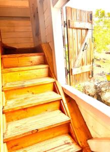 uma escada de madeira com uma porta aberta em 971C - "Ti Calebasse" an atypical cottage em Terre-de-Bas