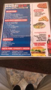 a menu for a fast food restaurant with a sandwich at El Currican Juan Dolio in Juan Dolio